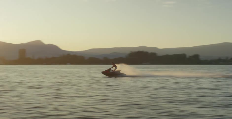 Jet ski being driven over the lake at a high speed