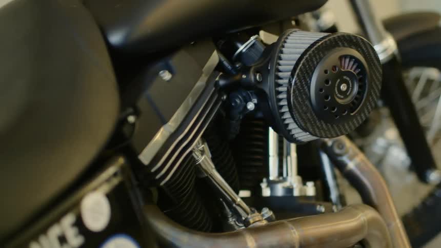 An engine and seat of a motorcycle indoors
