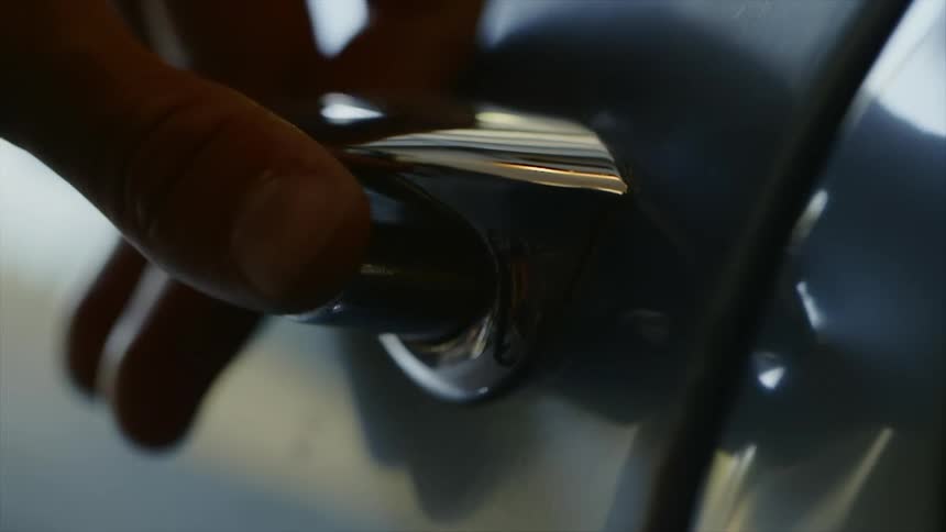 A man opens a car door