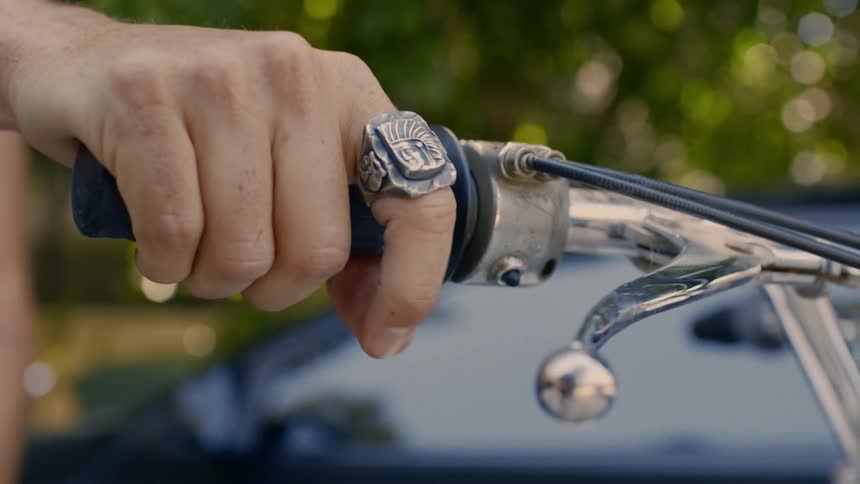 A person is turning the handle on the motorcycle