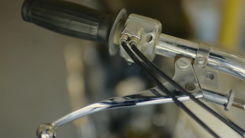 Handle bars on a bicycle shake as someone walks past a bike rack