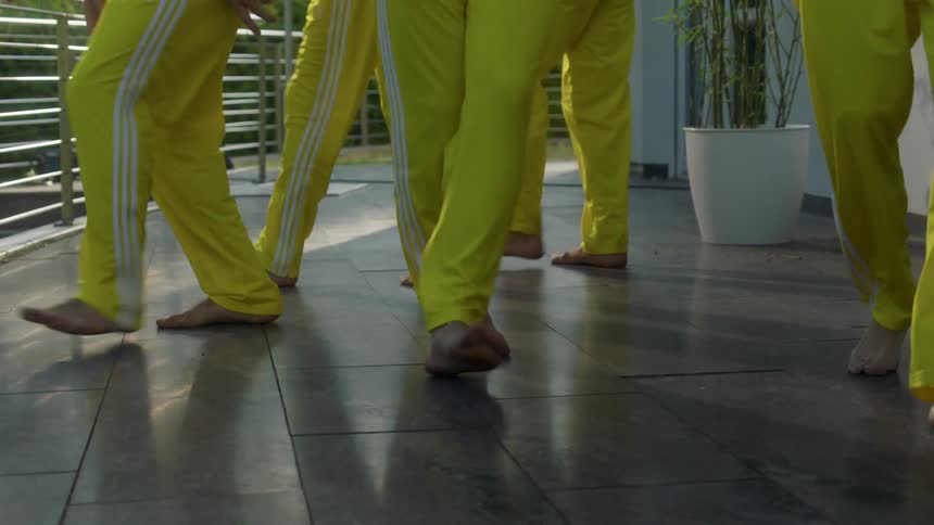 A group of people dance in a room