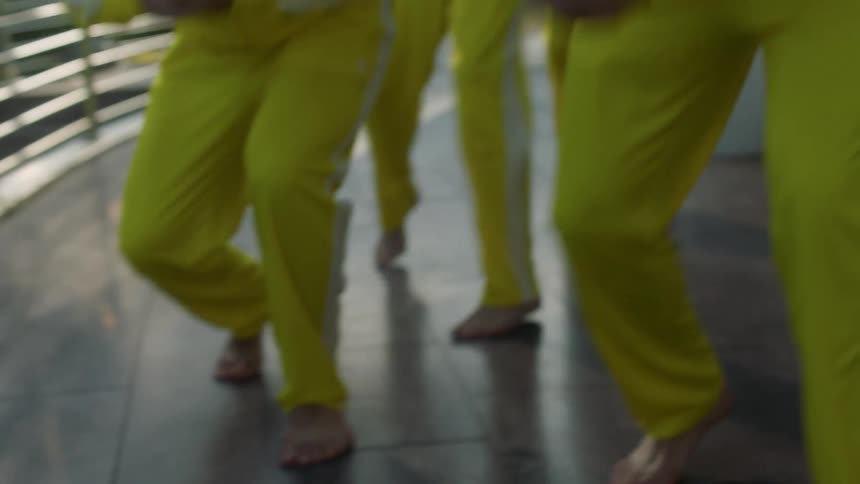 A group of teens practice a dance routine
