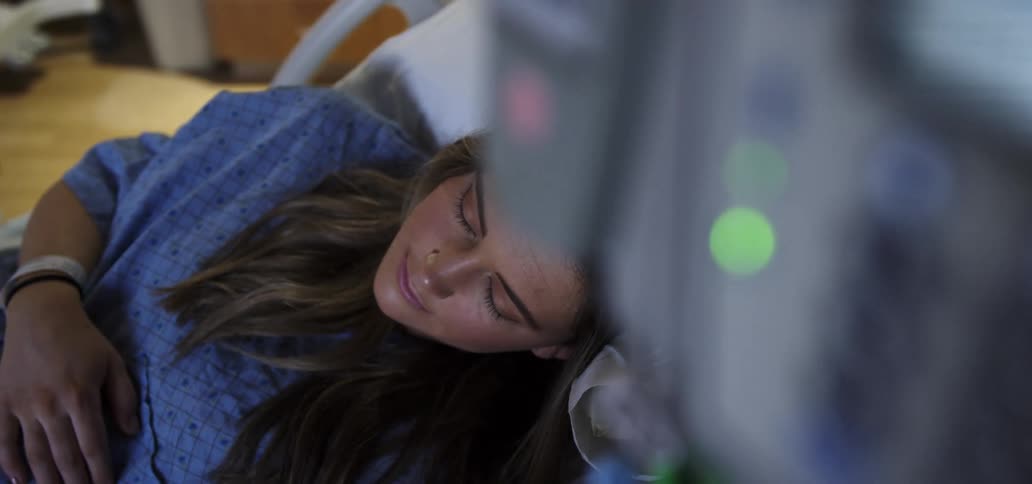 Female patient sleeping on a hospital bed