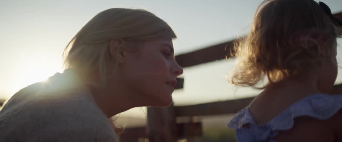 A mother looks out over the field with her daughter