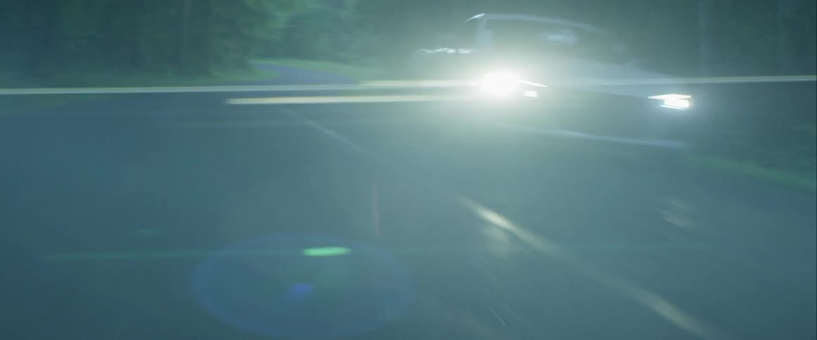 Passing a white sports car in the opposite lane on a two lane road