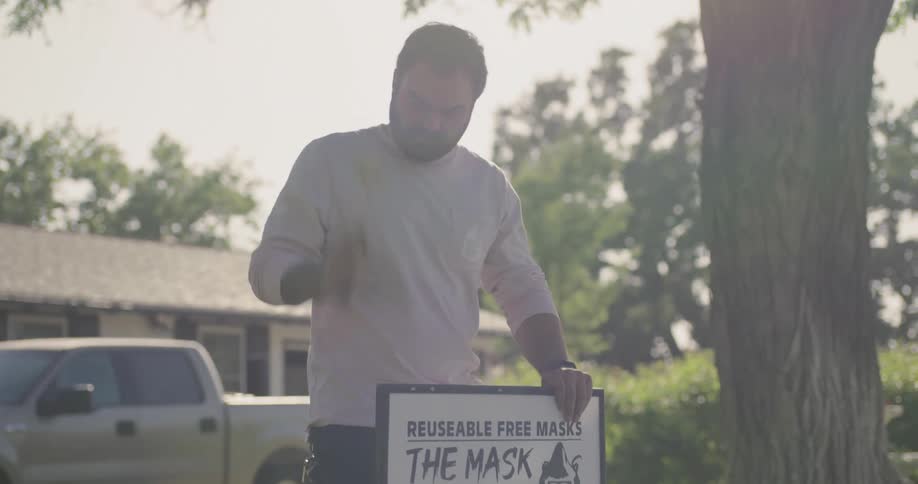 Man places a sign in his front yard