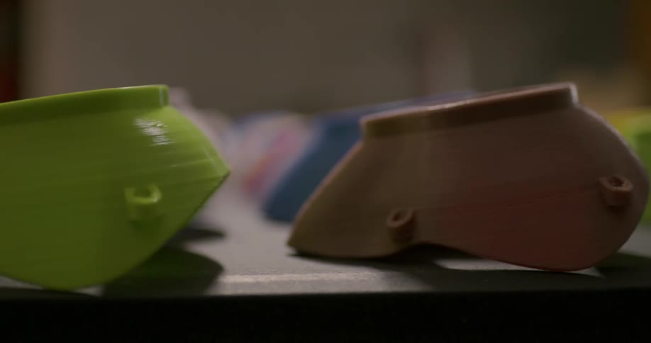 Rows of various colored containers lay on flat black surface