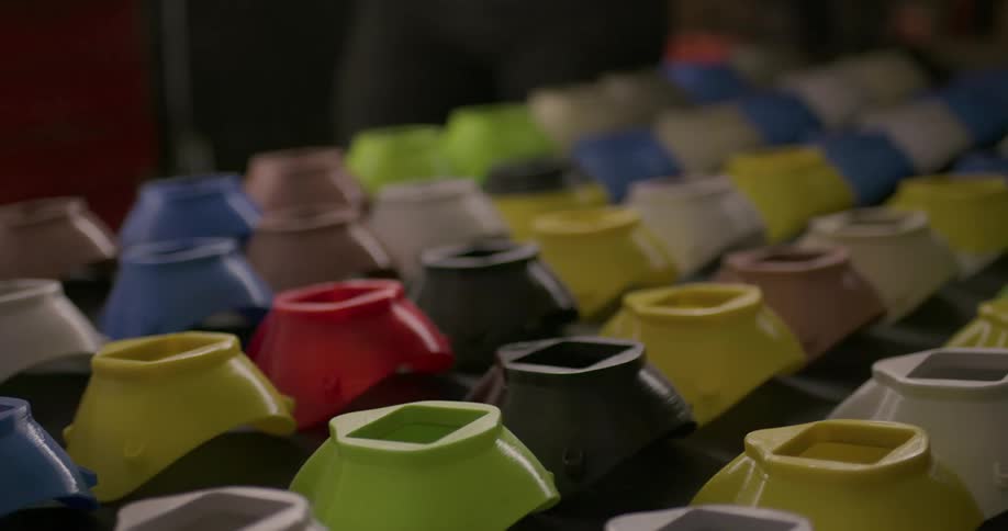 A row of similar but different colored plastic containers
