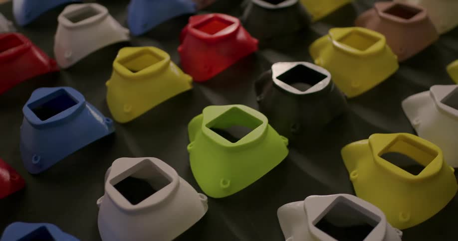 Rows of different colored plastic products sit on a table