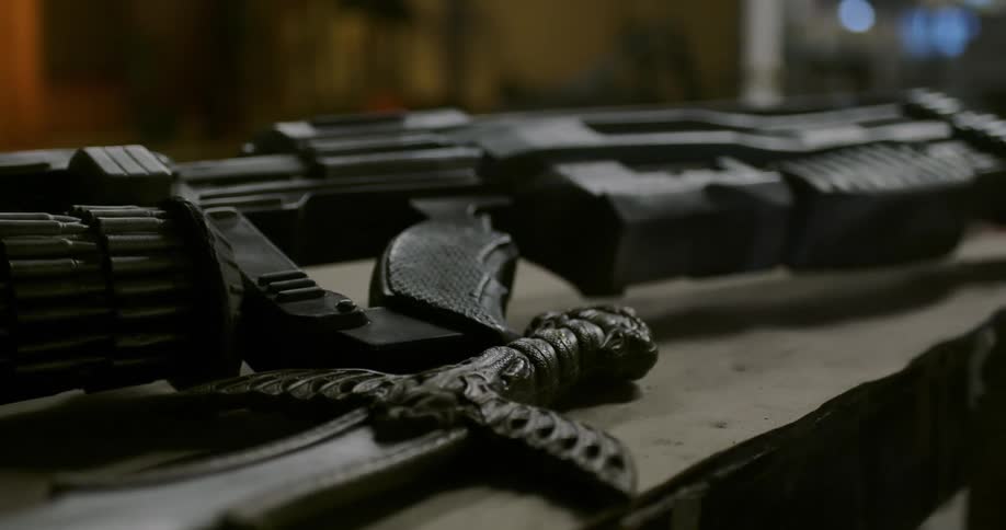 A gun and a knife on a counter
