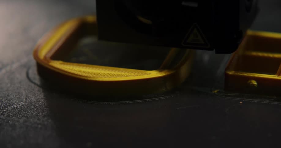 A machine polishes gold hardware on black leather