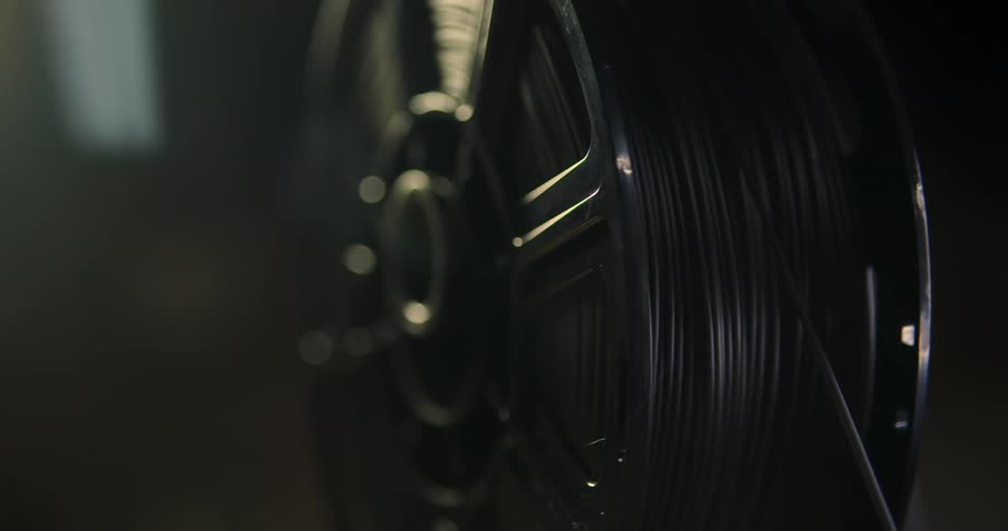 The spool slowly turns in the dark room