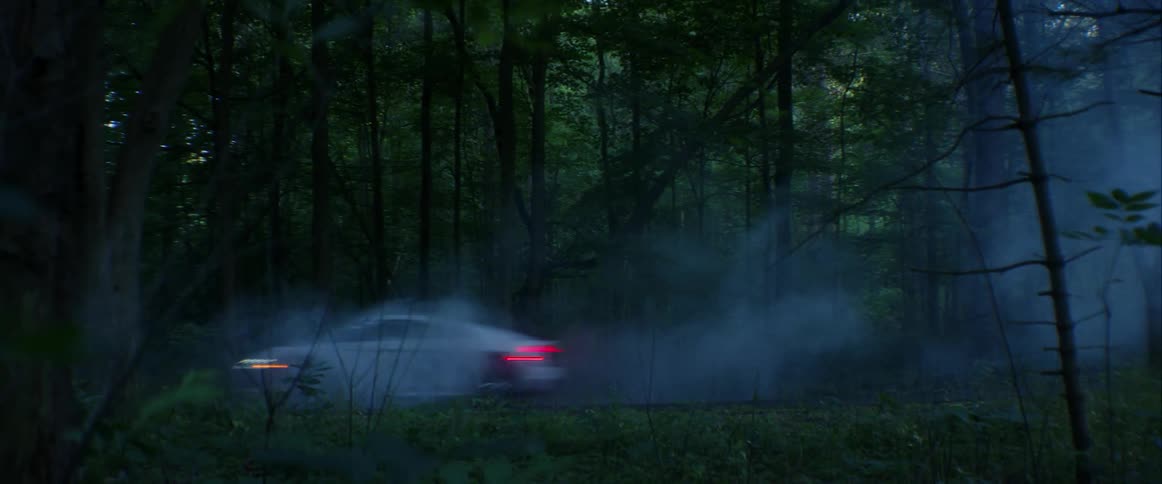 Sports car driving down a foggy highway