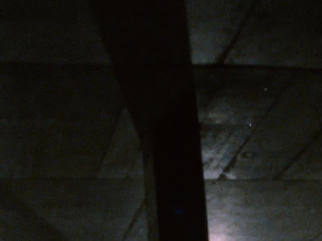 The hall is dark with many pillars