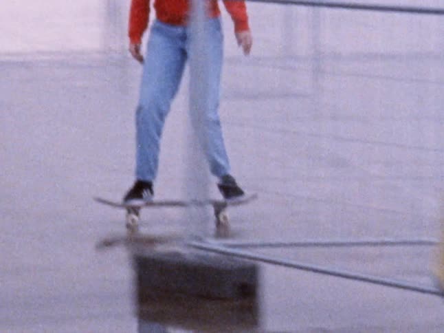 A teenager skateboards past an airport