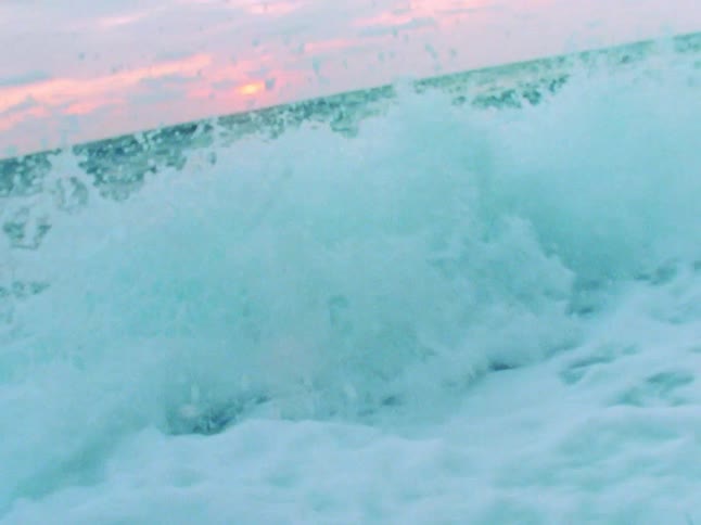 Large waves rise and fall and in the ocean