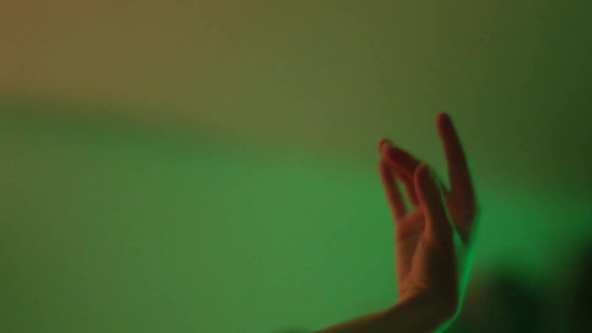 Woman dancing in a room with colorful lights