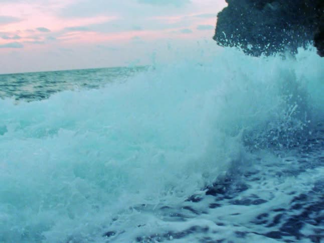 Waves in the ocean crash in to a cliff