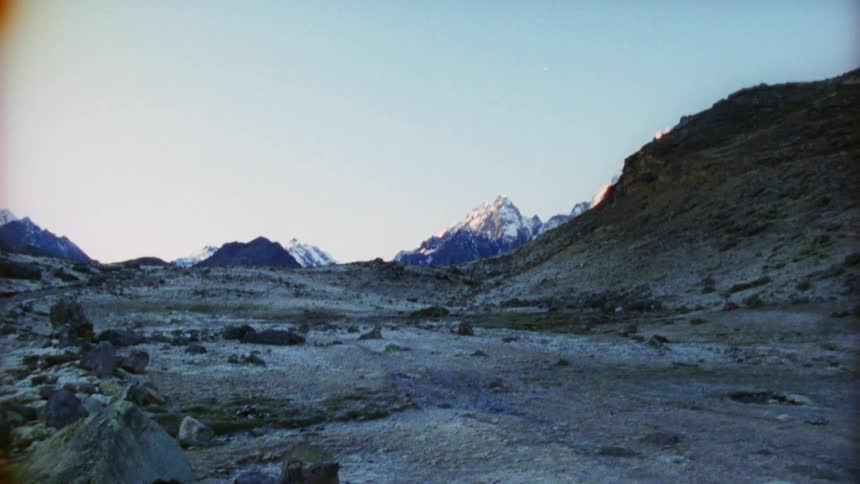 Rocks lay on the flat land next to the hill