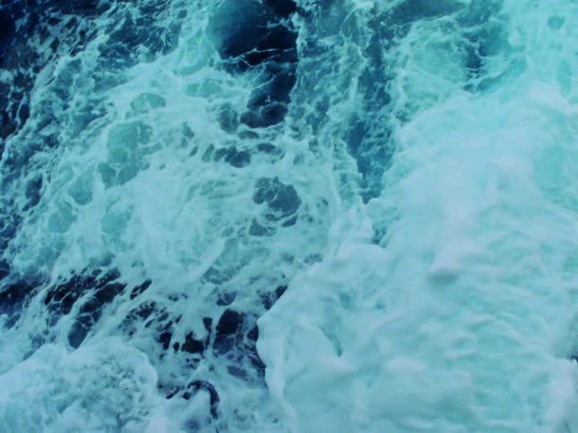 An aerial view of ocean water is displayed