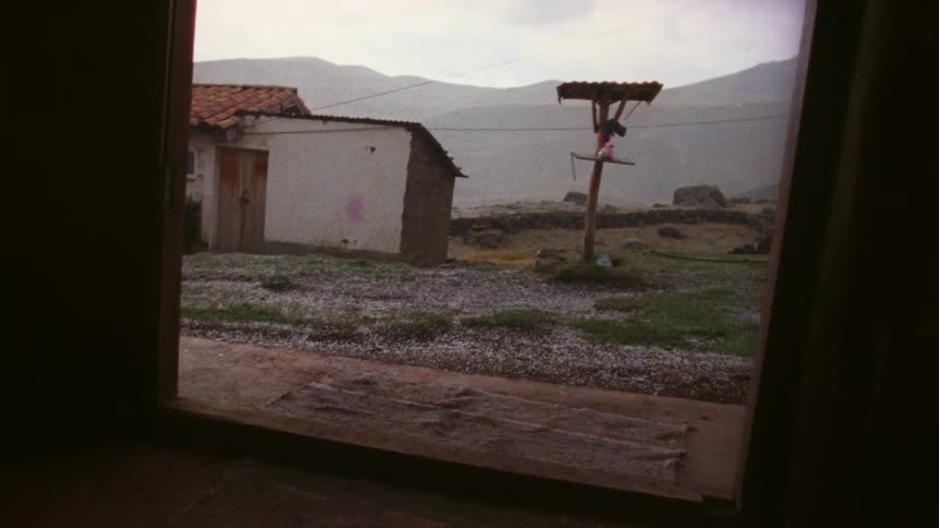 A small building connected to a power pole in a rural area