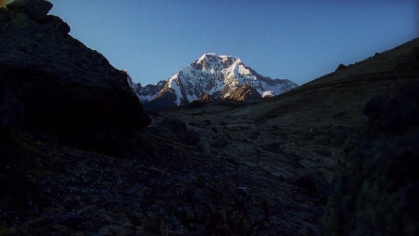 The mountains ahead are covered with snow at the top