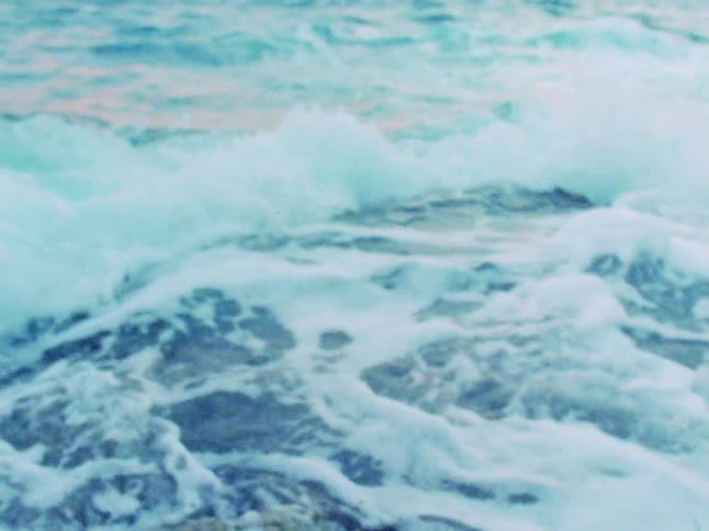 Ocean waves crest and crash into foam
