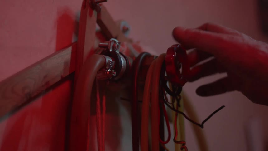 A red light flashes as a firefighter turns on a hose