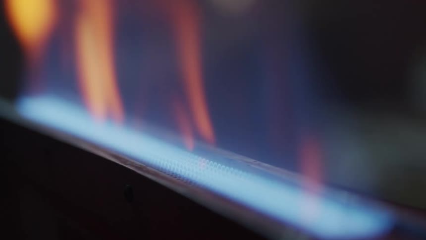 A machine emits a flame from a blue filament