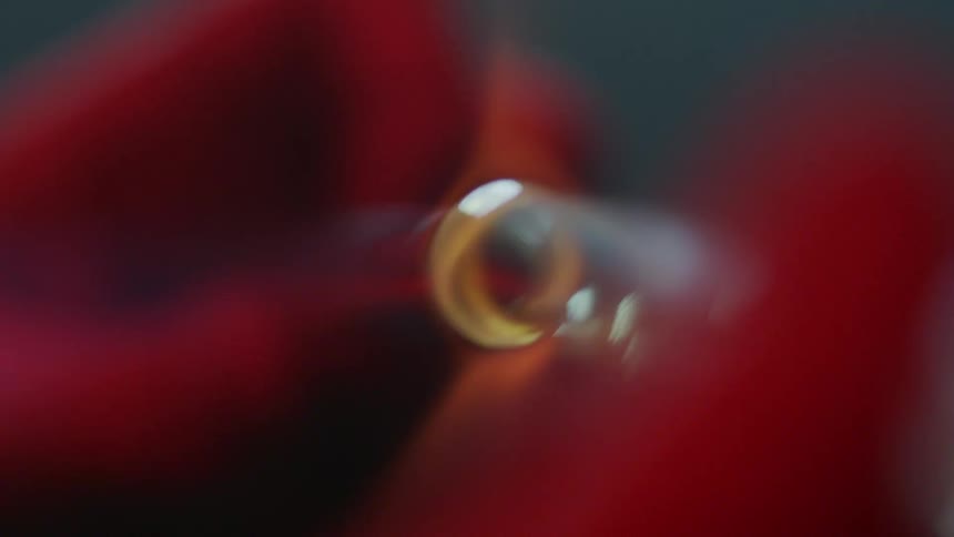 A person turns a burning tube