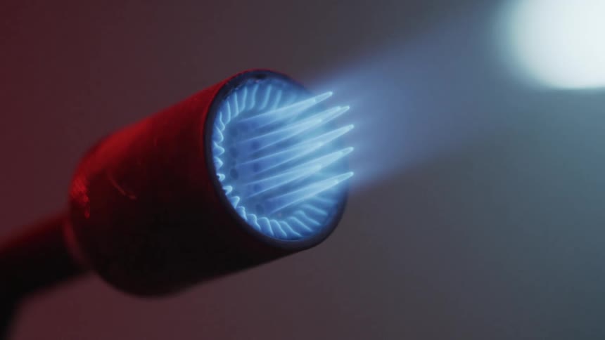A torch is giving off a blue flame