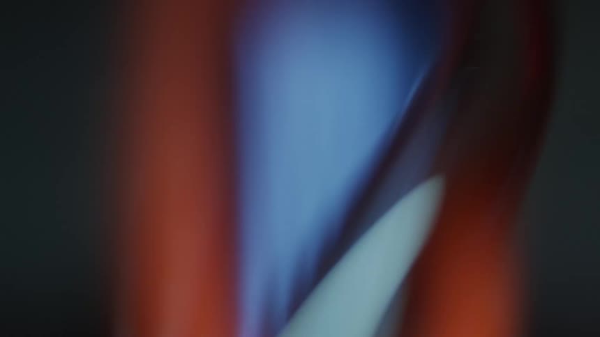 Flame reflecting on curved glass
