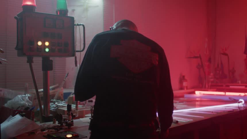 A man works on equipment in a shop