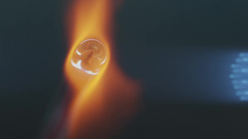Piece of glass heating on the flames of a torch