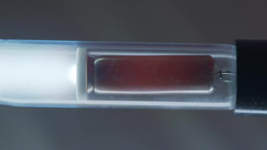A mechanical device with a flashing bulb inside of it