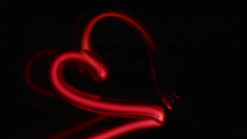The filament of a red light begins to shine dimly before suddenly brightening