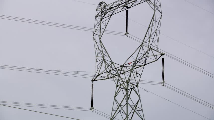 Dynamic pass by shot of a high transmission electric transport line moving energy across the world