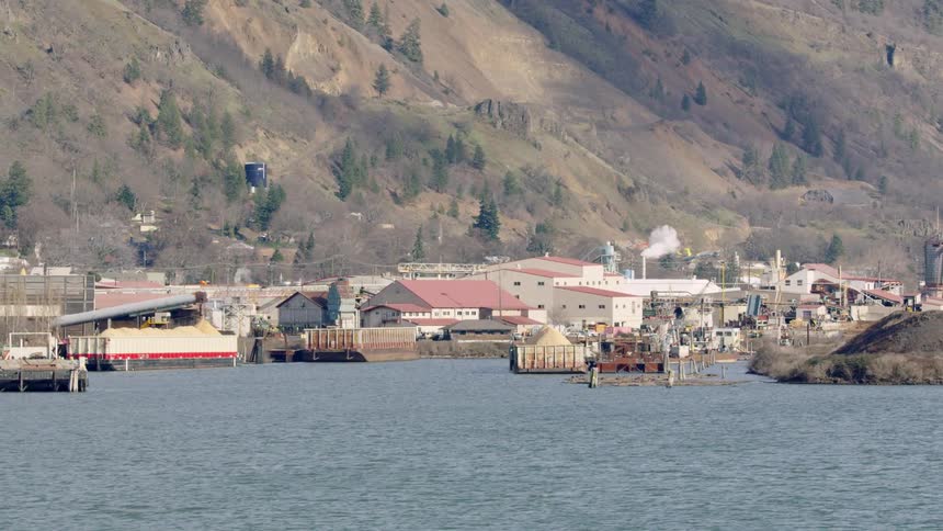 Inland marina on the Columbia River with a large sawmill in the background hard at work