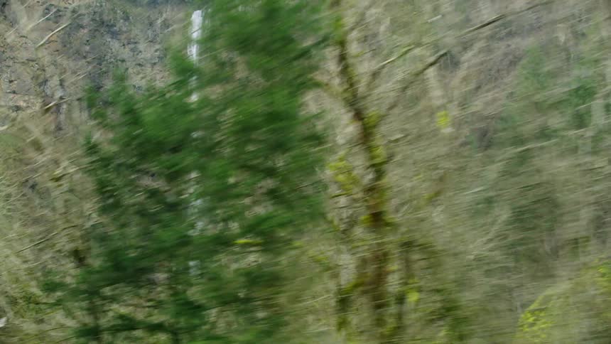 Looking up at Multnomah Falls from the highway perspective as the camera passes by the largest waterfall in Oregon