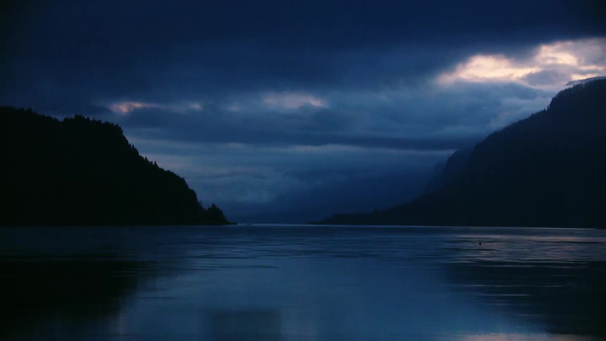 Looking up the Columbia River just before the sun rises with beautiful blue and pink clouds illuminating the Columbia River Gorge
