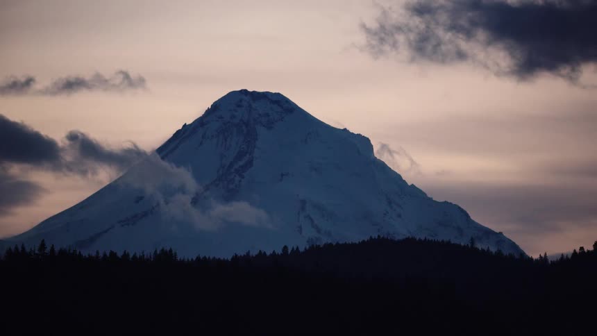 Beautiful post sunset shot of Mount Hood as dynamic clouds hang low on the horizon before the scene is obscured by a passing object