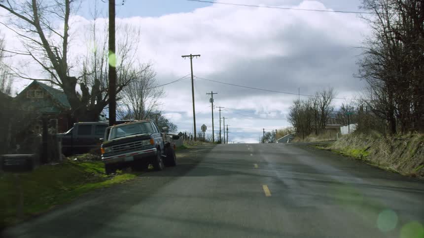 Driving through a rural working town deep in the Pacific Northwest as residents get home from land days working nearby jobs