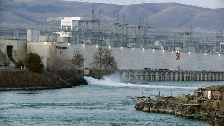 A power station dam offloads water into the Columbia River