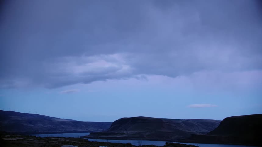 Blue hour shot looking out over the Columbia River Gorge as the camera shows a dynamic cloudscape