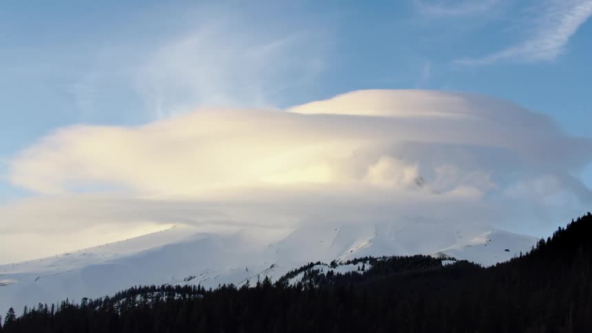 Extreme winds scour the summit of Mount Hood in the heart of winter as sunset light illuminates the cold and picturesque scene