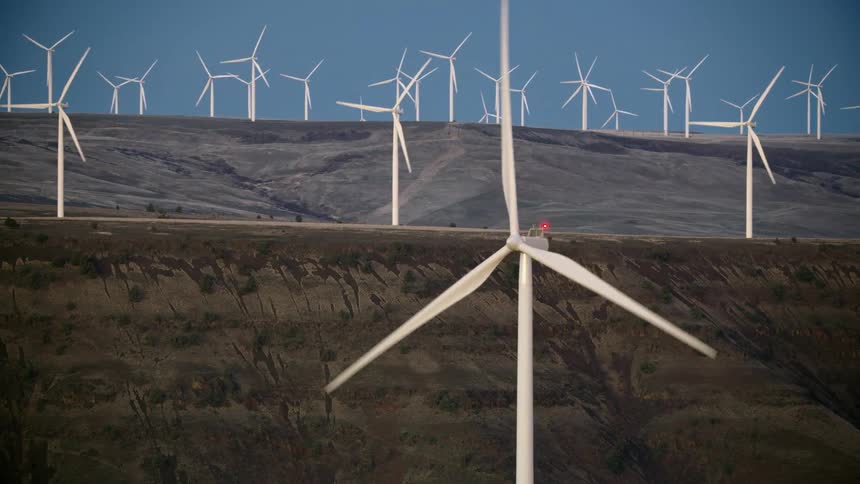 Many wind turbines rotate in this mesmerizing shot of clean renewable electricity being harvested off nothing but blowing wind