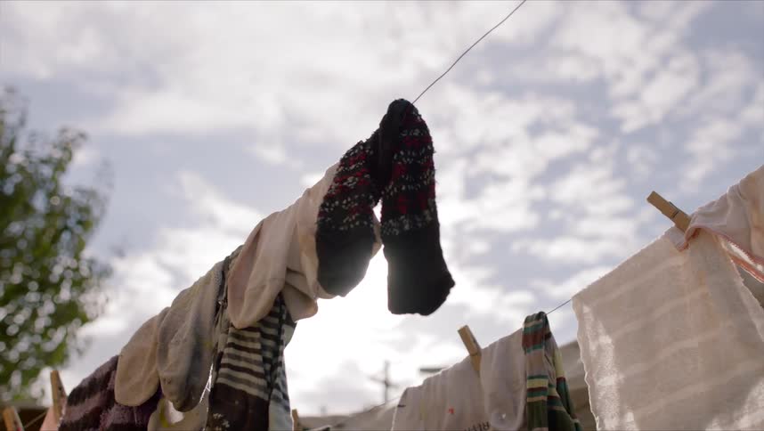 Clothes drying on a clothesline outside a house