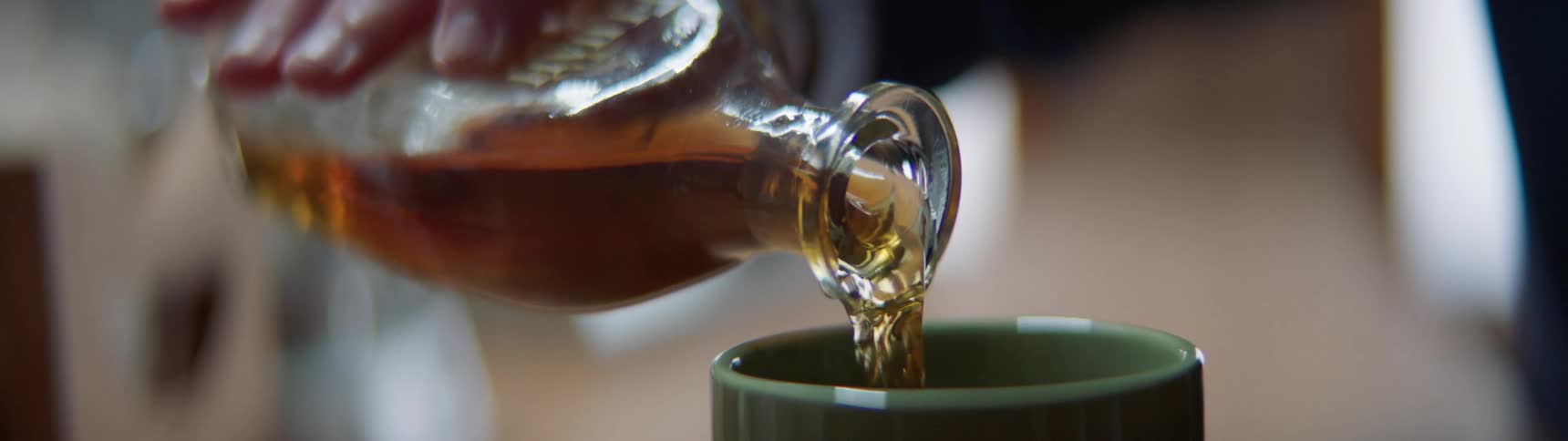Alcohol being poured into a coffee cup at the office