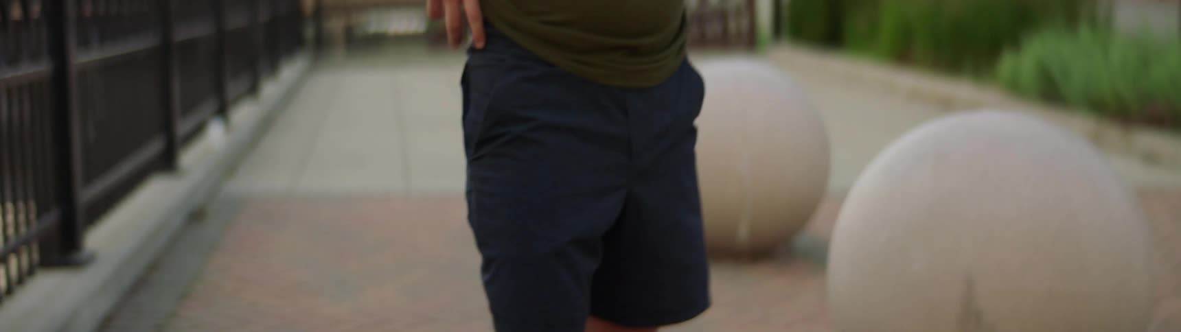 A young man stands outside and looks around